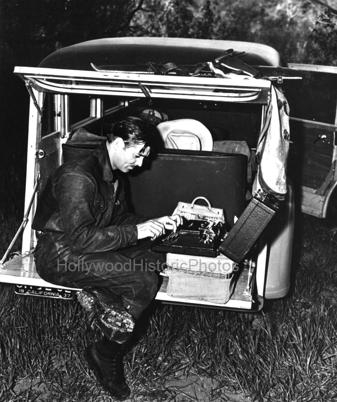 Clark Gable 1937 On location writing on his typewriter WM.jpg